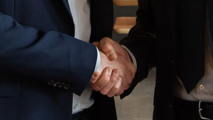 Two business partners shaking hands