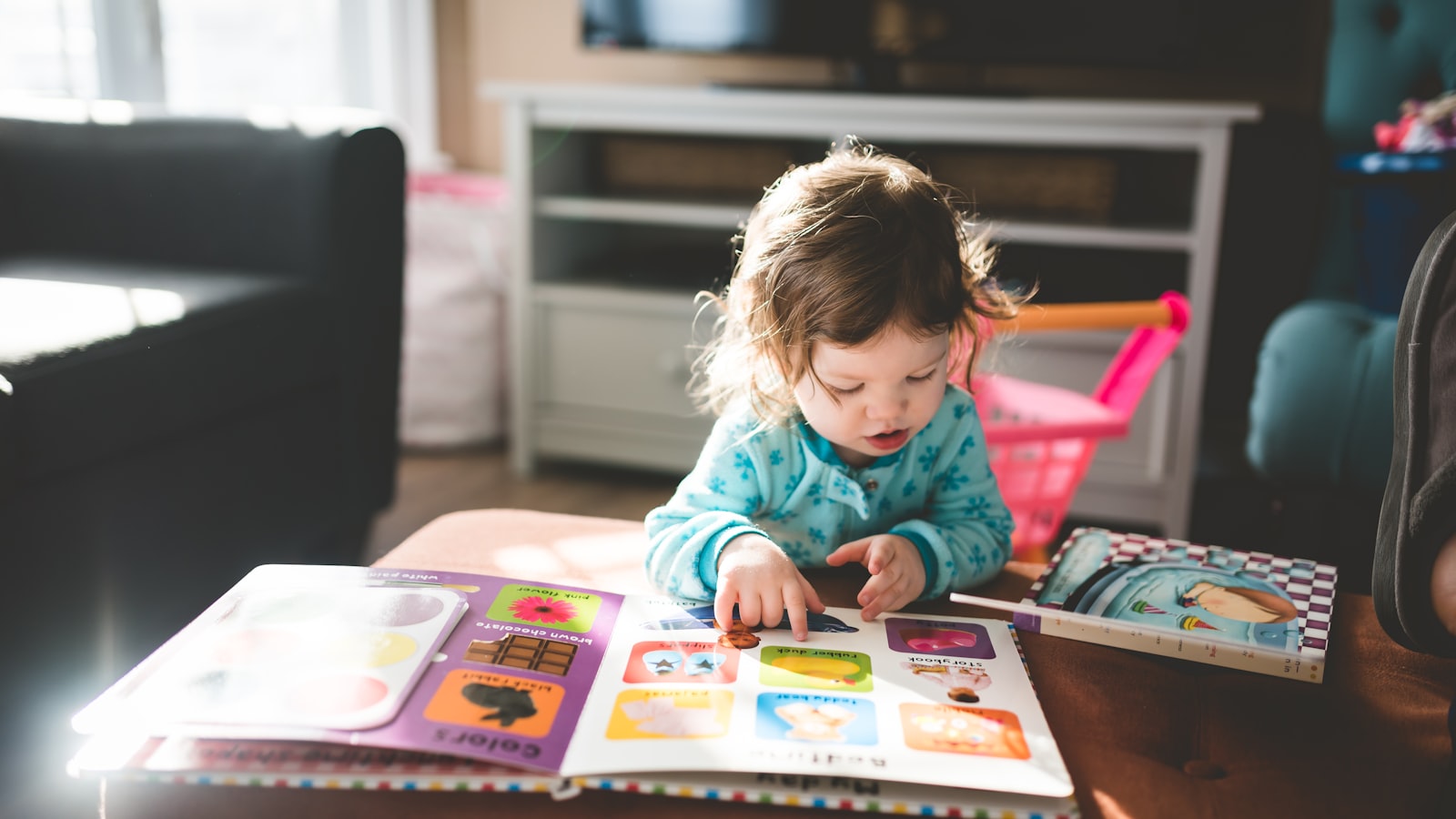A young child engrossed in a picture book